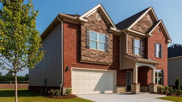 a view of a house with a yard and balcony