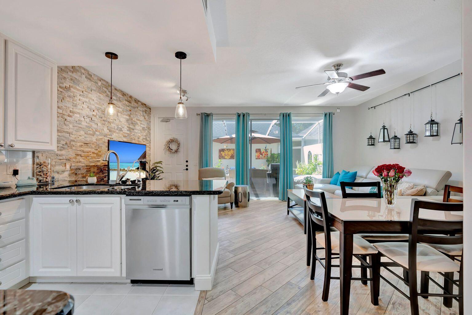 180 Freeport Drive Jupiter, FL 33458 - Photo 12 of 34 a view of a dining room with furniture and wooden floor