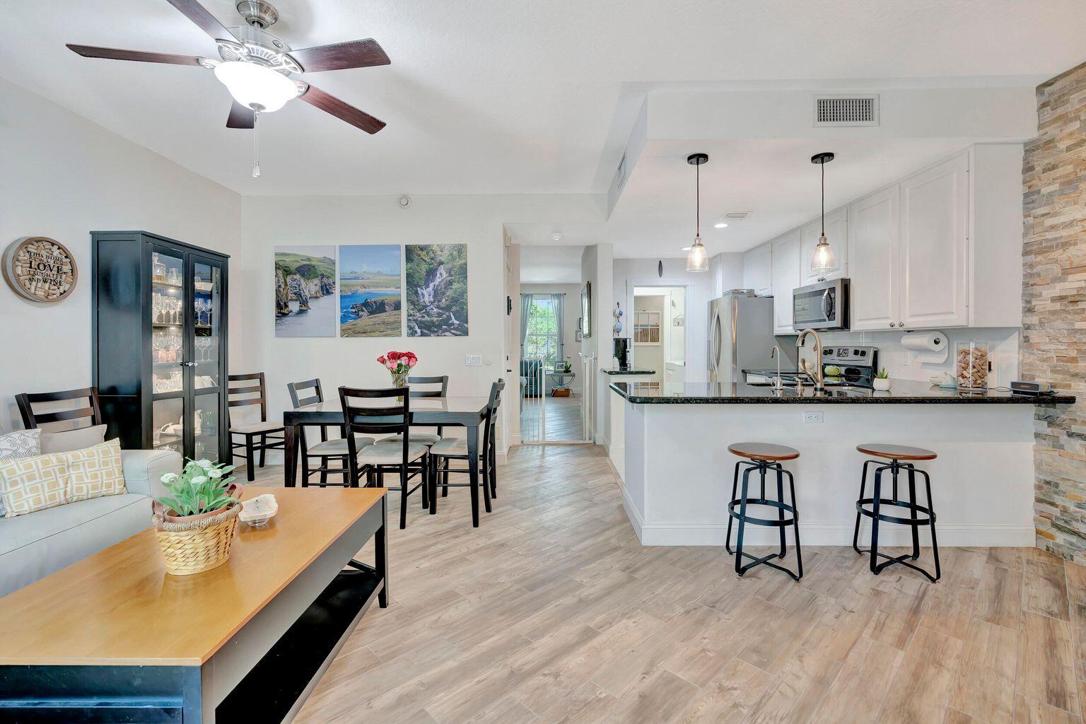 180 Freeport Drive Jupiter, FL 33458 - Photo 18 of 34 a living room with stainless steel appliances kitchen island granite countertop furniture and a kitchen view