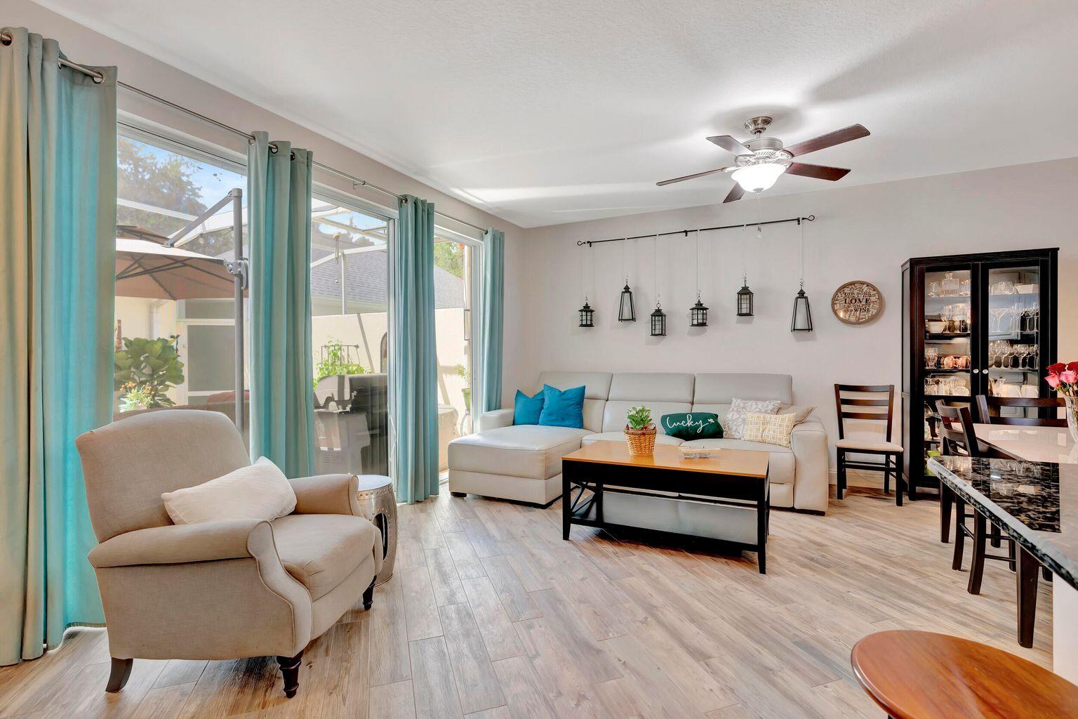 180 Freeport Drive Jupiter, FL 33458 - Photo 19 of 34 a living room with furniture and wooden floor