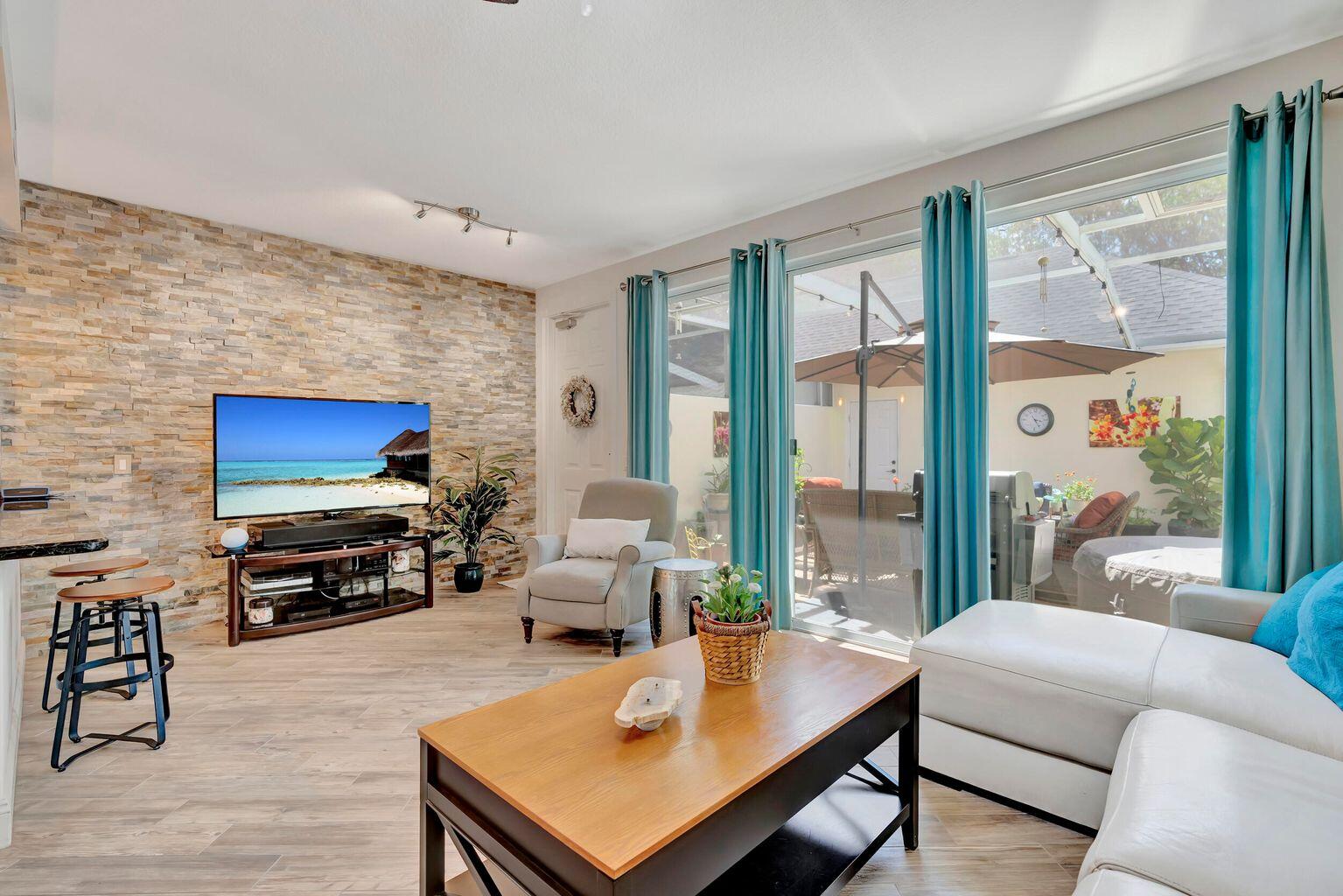 180 Freeport Drive Jupiter, FL 33458 - Photo 21 of 34 a living room with furniture and a flat screen tv