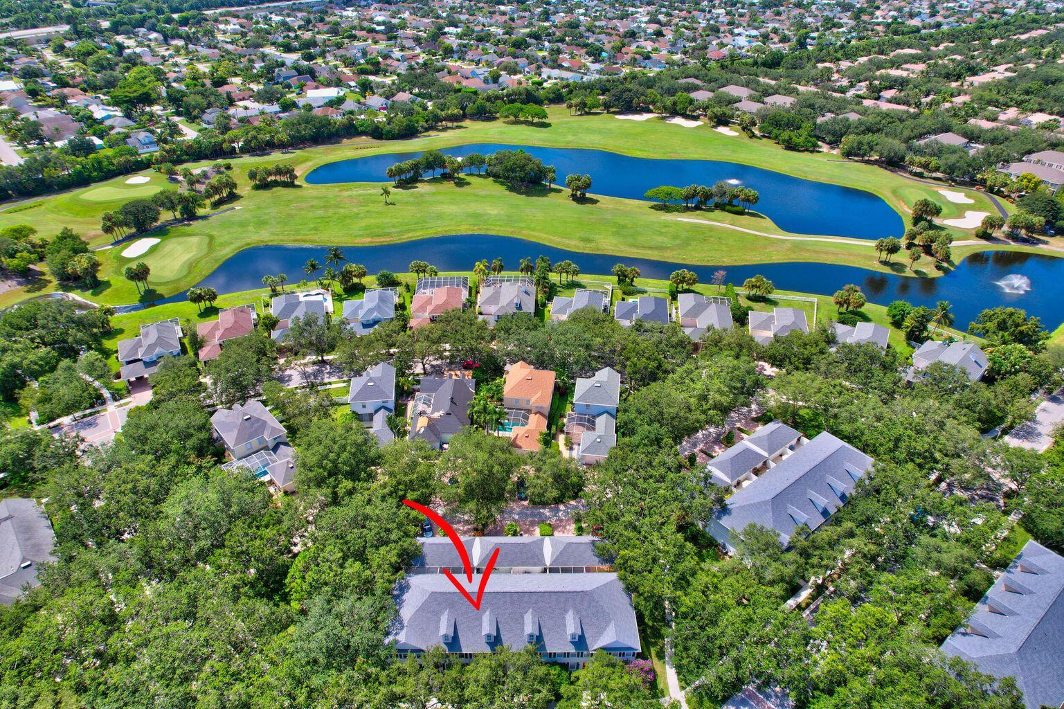 180 Freeport Drive Jupiter, FL 33458 - Photo 3 of 34 an aerial view of a house with a garden and lake view