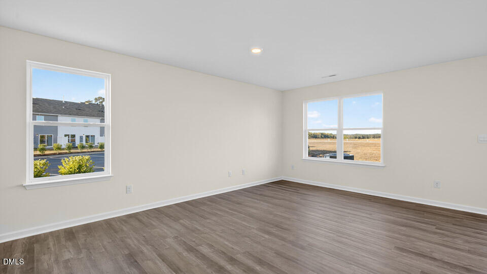 11 Red Clover Drive Angier, NC 27501 - Photo 13 of 33 an empty room with wooden floor and windows