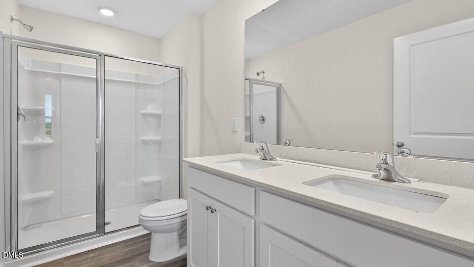 11 Red Clover Drive Angier, NC 27501 - Photo 24 of 33 a bathroom with a granite countertop sink a toilet and shower