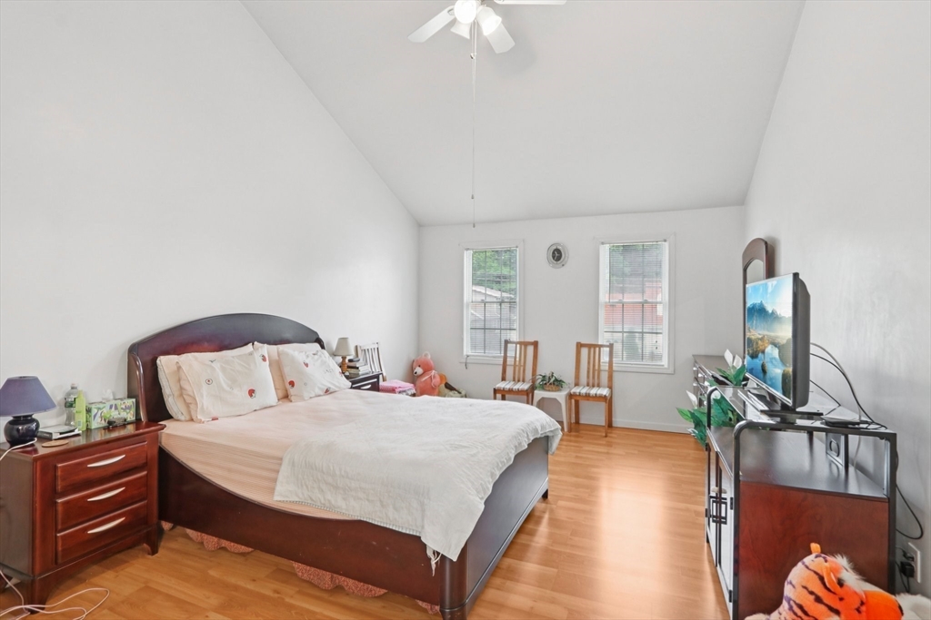 469 North Street Randolph, MA 02368 - Photo 22 of 42 a spacious bedroom with a bed and a chandelier