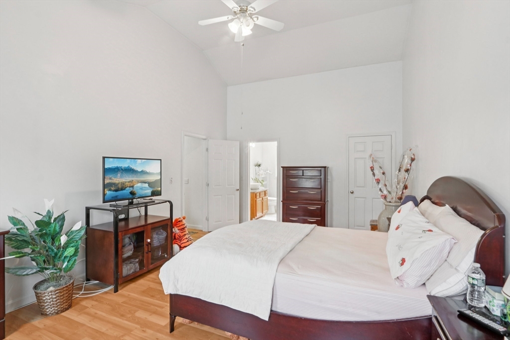 469 North Street Randolph, MA 02368 - Photo 23 of 42 a bedroom with a bed and a chandelier