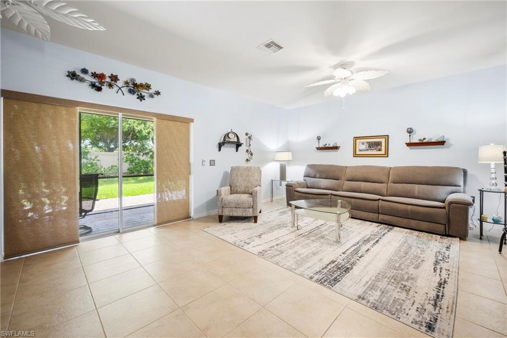 3916 Cherrybrook Loop Fort Myers, FL 33966 - Photo 7 of 31 Spacious living area featuring neutral tile flooring, light-toned wall paint, and a white ceiling fan