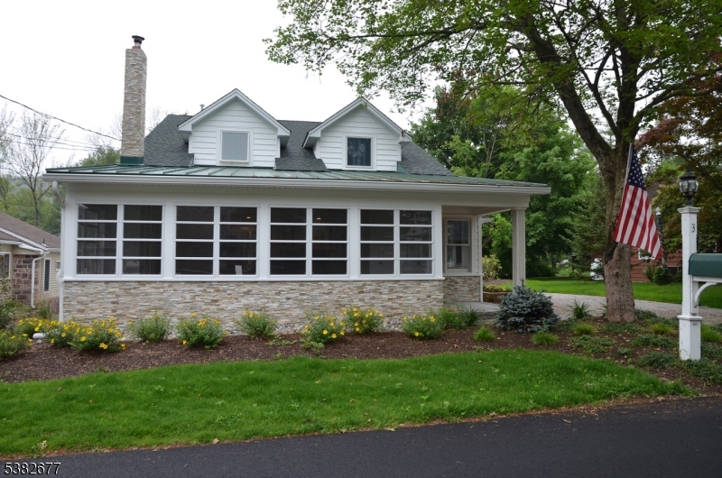 a front view of a house with a garden and plants