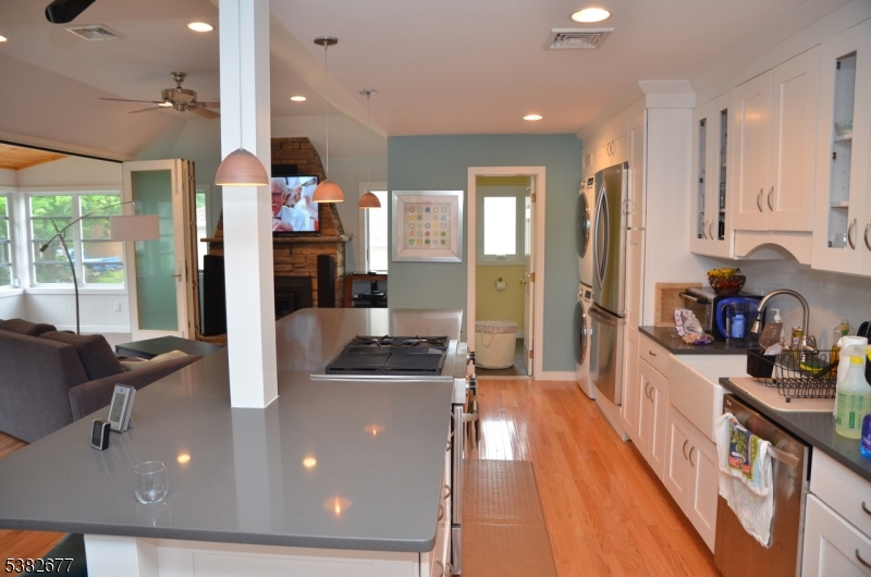 3 Old Lane Newfoundland, NJ 07435 - Photo 7 of 15 a kitchen with stainless steel appliances granite countertop a refrigerator a sink dishwasher a oven and a dining table with wooden floor