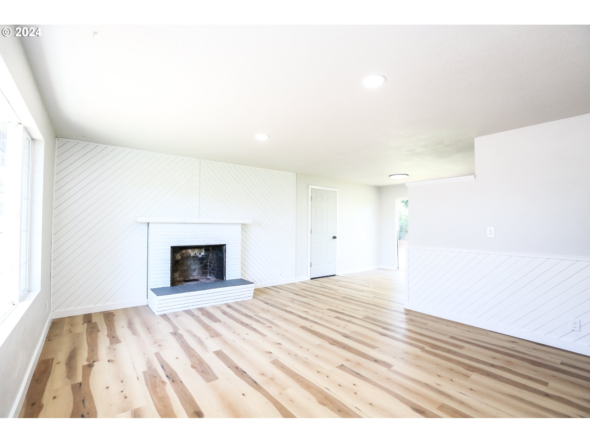 1828 Swank Court Springfield, OR 97477 - Photo 4 of 24 a view of empty room with wooden floor and fireplace