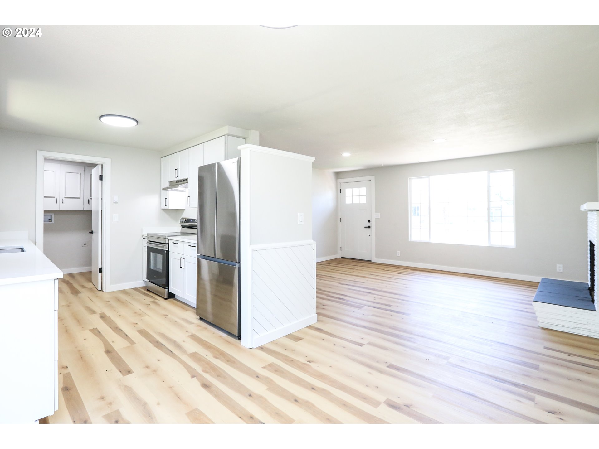 1828 Swank Court Springfield, OR 97477 - Photo 8 of 24 a view of a kitchen with wooden floor electronic appliances and window