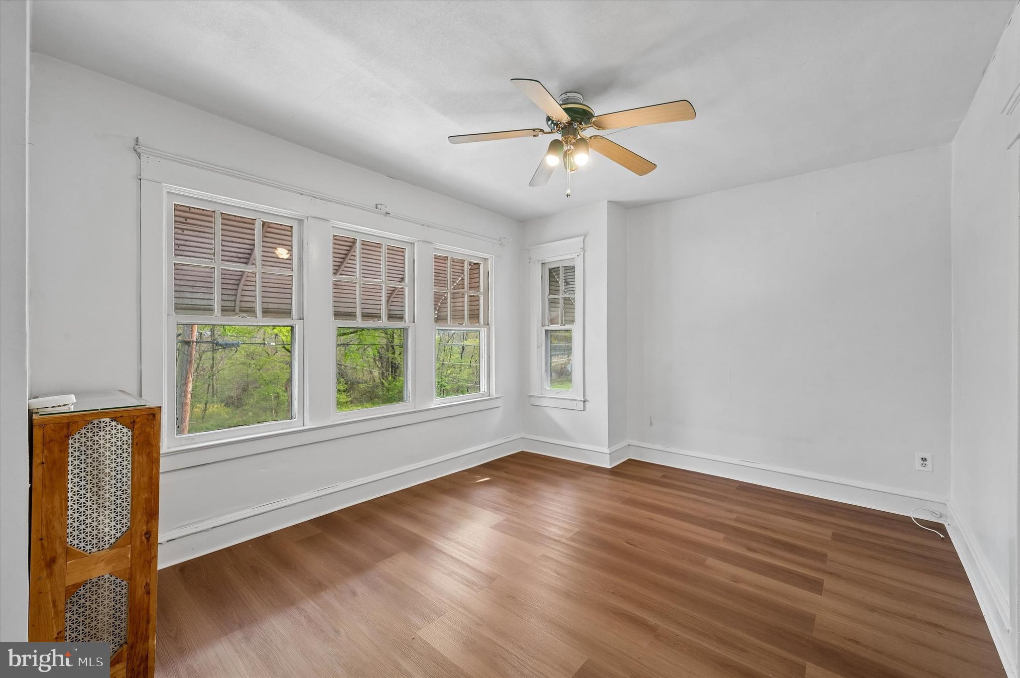 1008 East 18th Street Chester, PA 19013 - Photo 20 of 25 a view of an empty room with wooden floor and a window