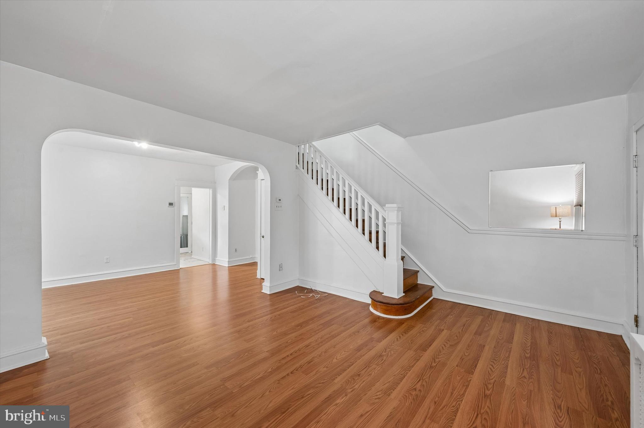 1008 East 18th Street Chester, PA 19013 - Photo 5 of 25 a view of an empty room with wooden floor and stairs