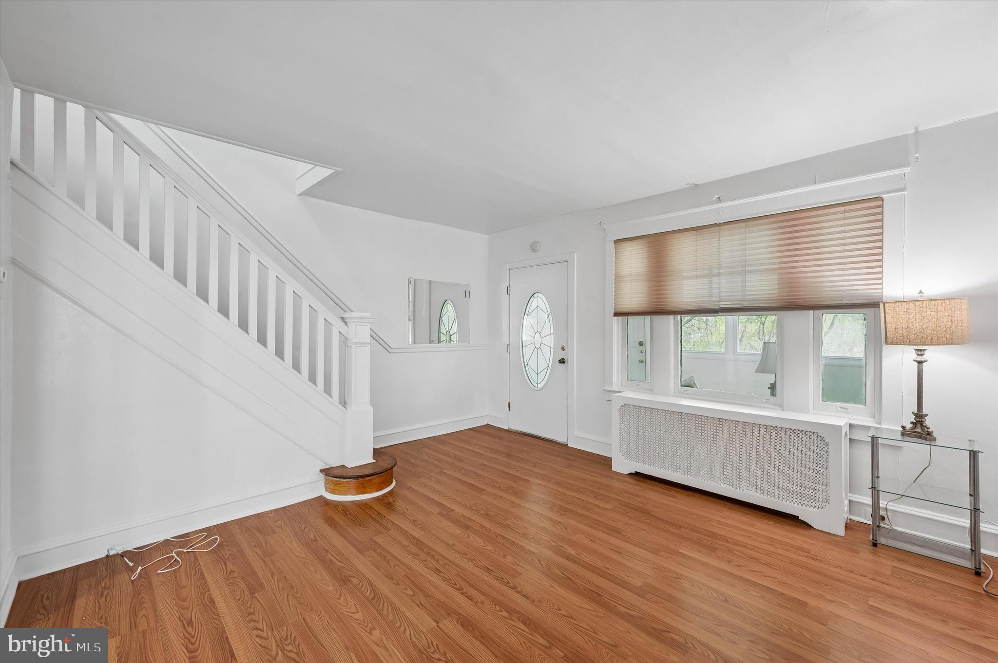 1008 East 18th Street Chester, PA 19013 - Photo 6 of 25 a view of an empty room with window and wooden floor