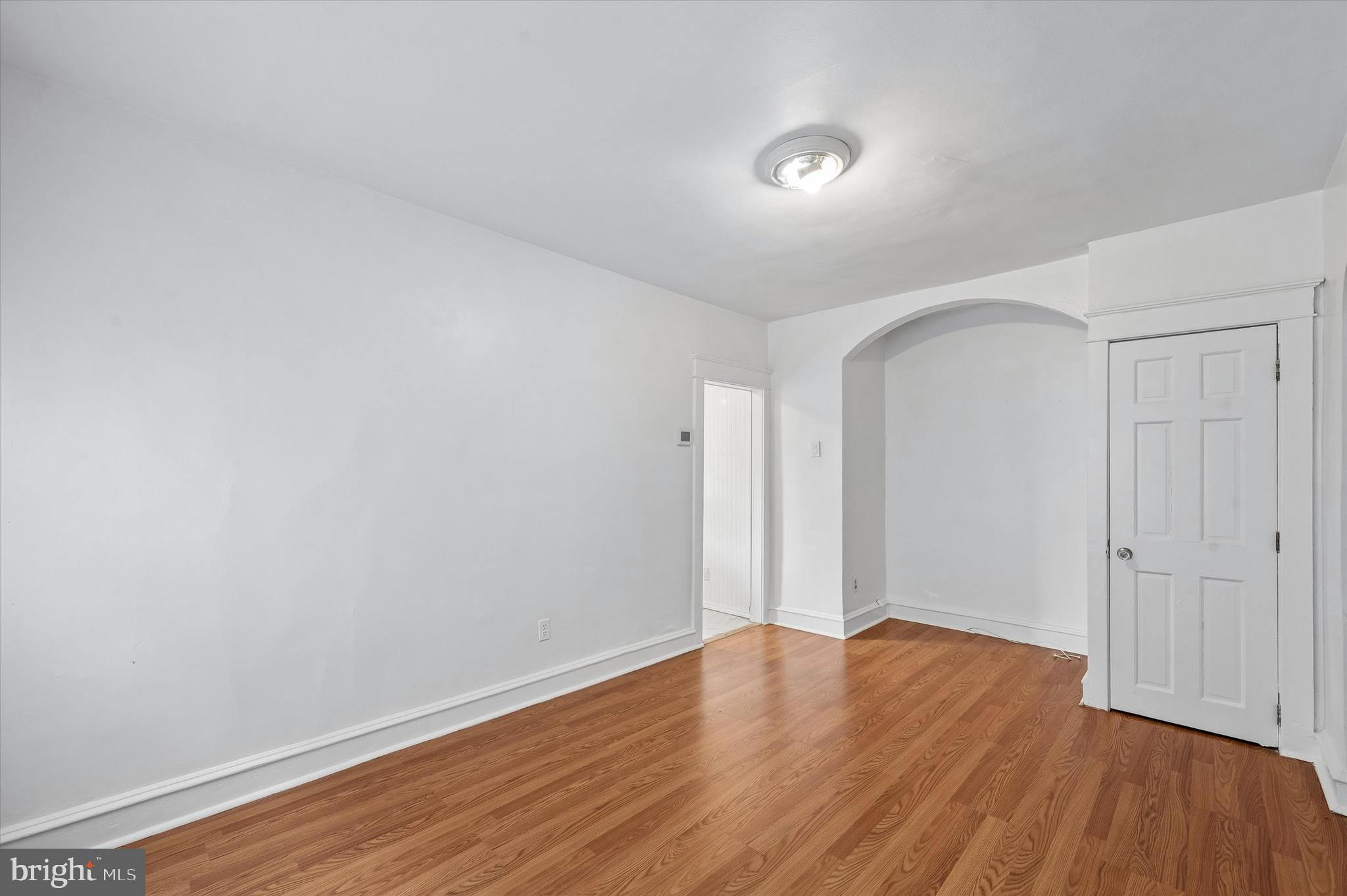 1008 East 18th Street Chester, PA 19013 - Photo 7 of 25 an empty room with wooden floor