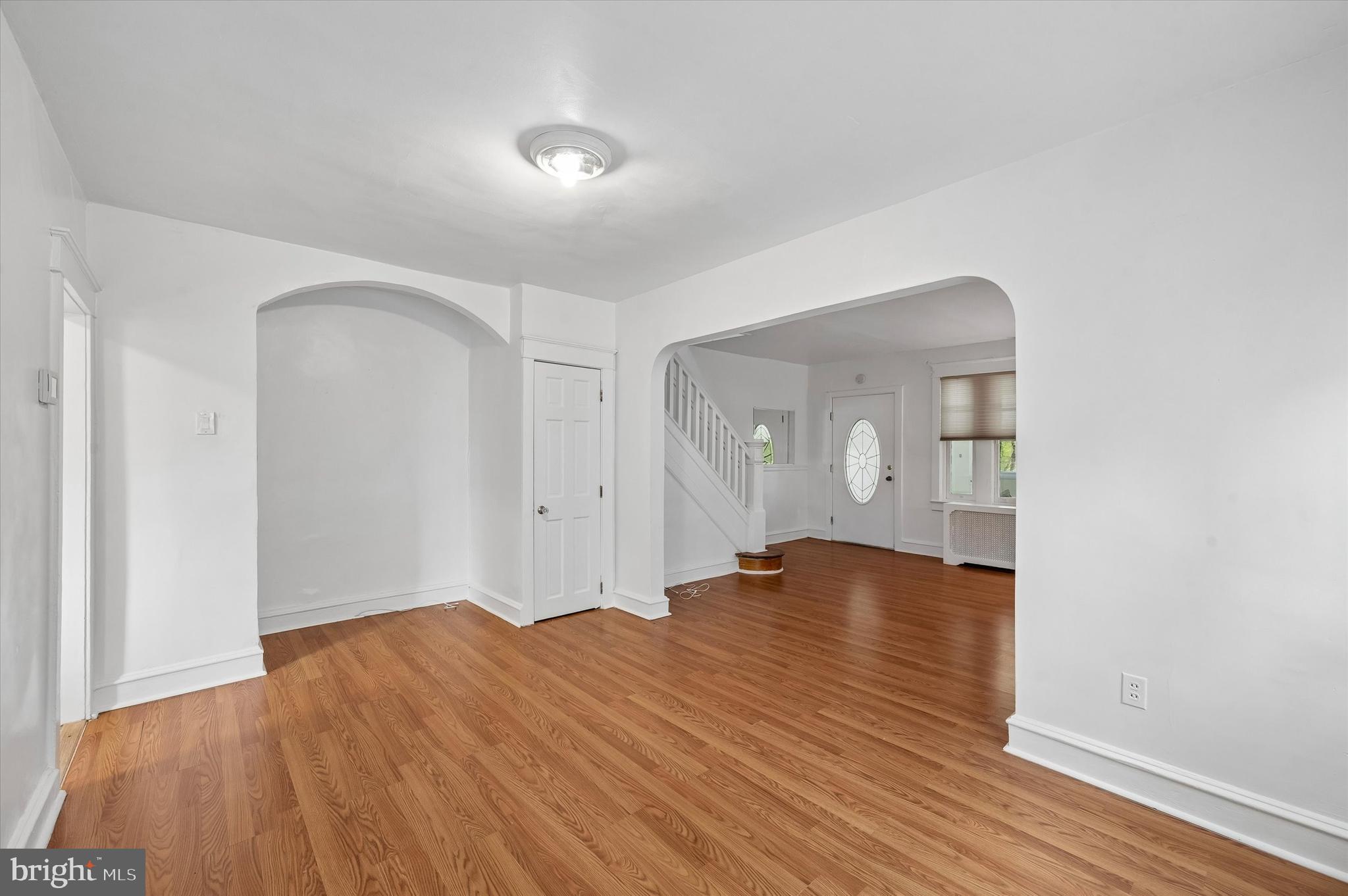 1008 East 18th Street Chester, PA 19013 - Photo 8 of 25 an empty room with wooden floor and windows