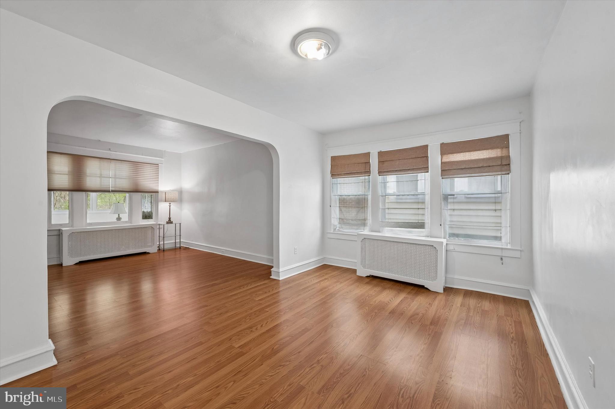 1008 East 18th Street Chester, PA 19013 - Photo 9 of 25 an empty room with wooden floor and windows