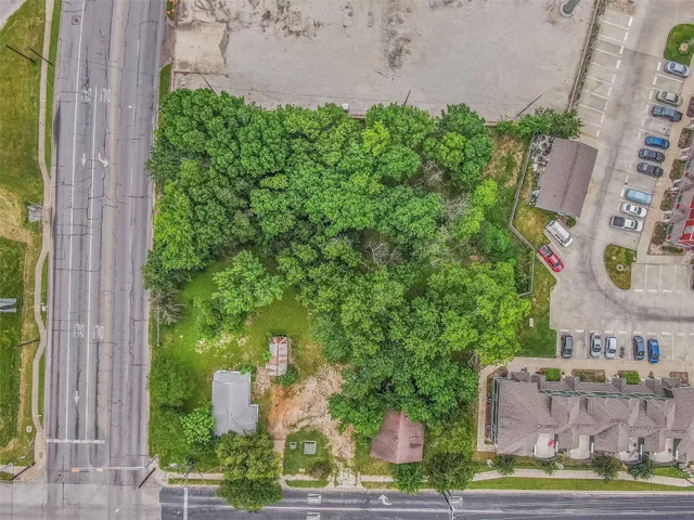 an aerial view of a house with a yard and garden