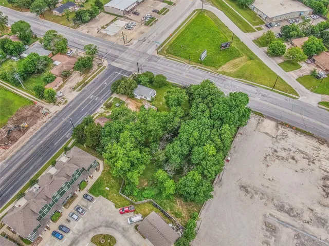 a view of a yard with potted plants