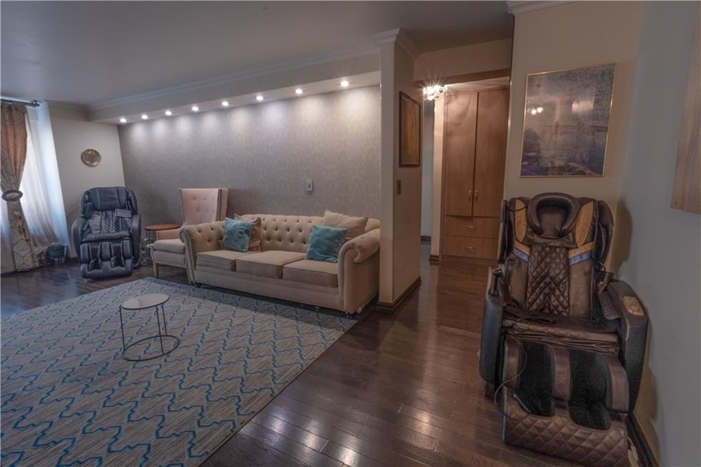 464 Neptune Avenue, Unit 3F Brooklyn, NY 11224 - Photo 2 of 15 a living room with furniture and a mirror