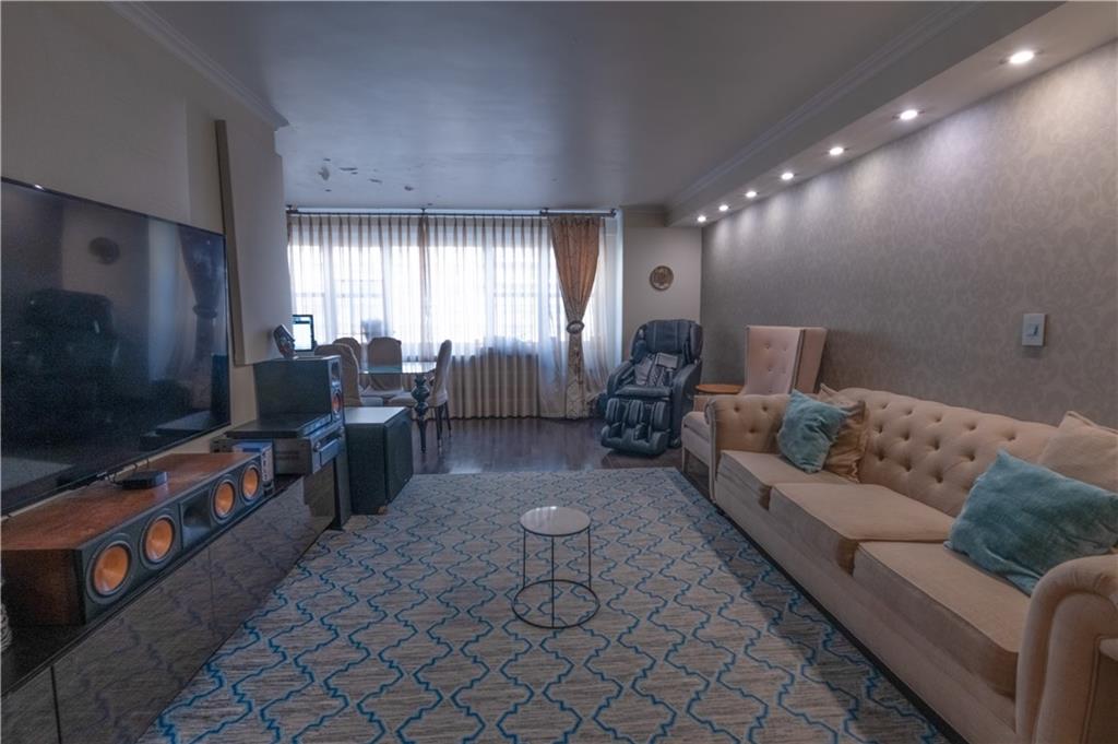 464 Neptune Avenue, Unit 3F Brooklyn, NY 11224 - Photo 3 of 15 a living room with furniture and a flat screen tv