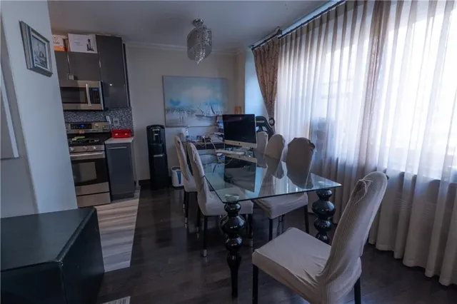 a view of a dining room with furniture and a window