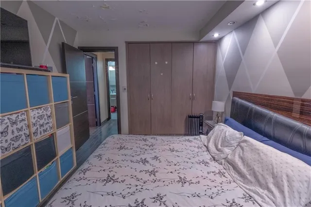 a bedroom with a bed and a large mirror