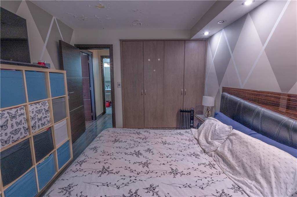 464 Neptune Avenue, Unit 3F Brooklyn, NY 11224 - Photo 10 of 15 a bedroom with a bed and a large mirror