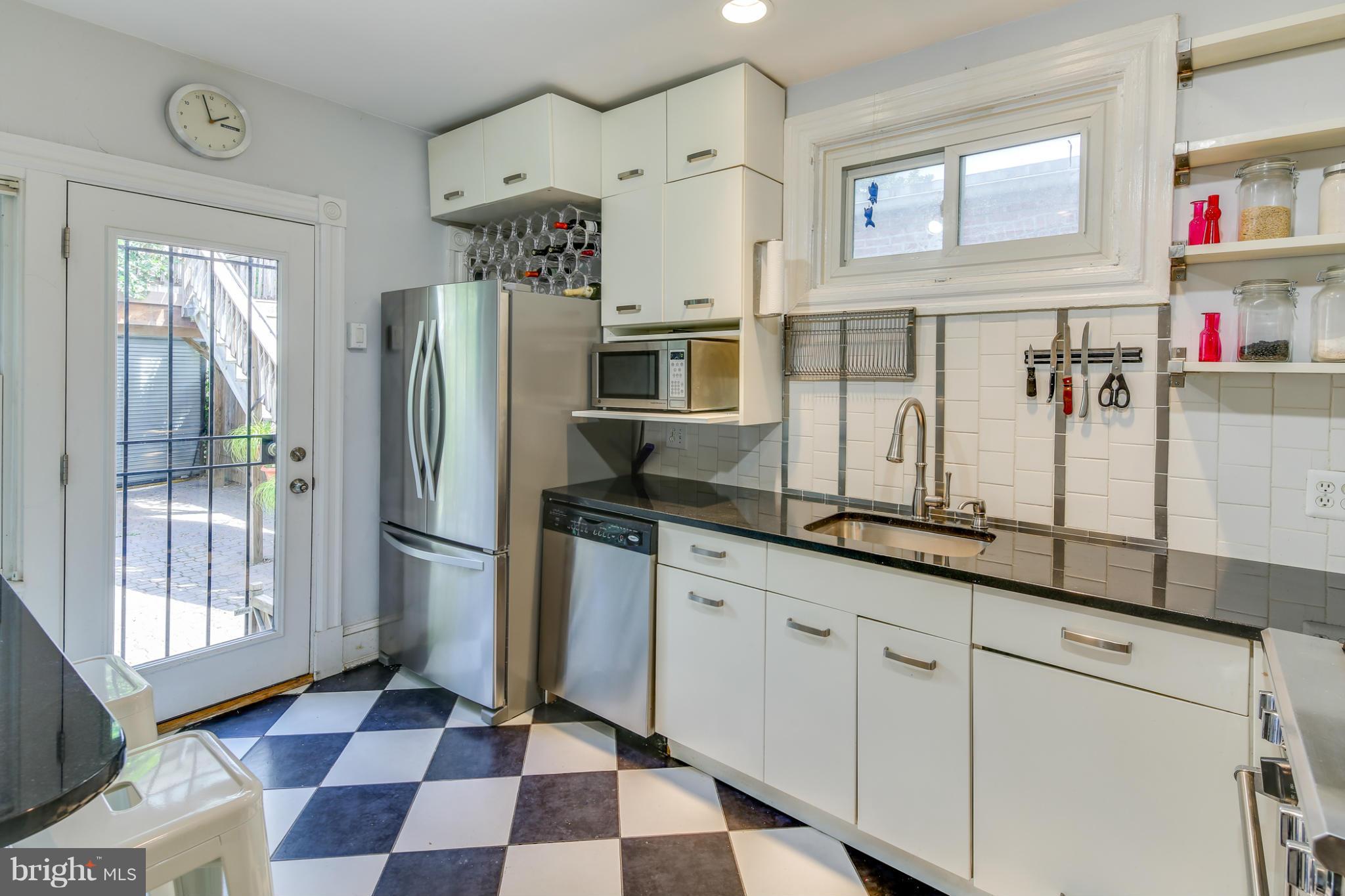 2317 Ontario Road Northwest Washington, DC 20009 - Photo 12 of 30 a kitchen with stainless steel appliances granite countertop a refrigerator and a sink