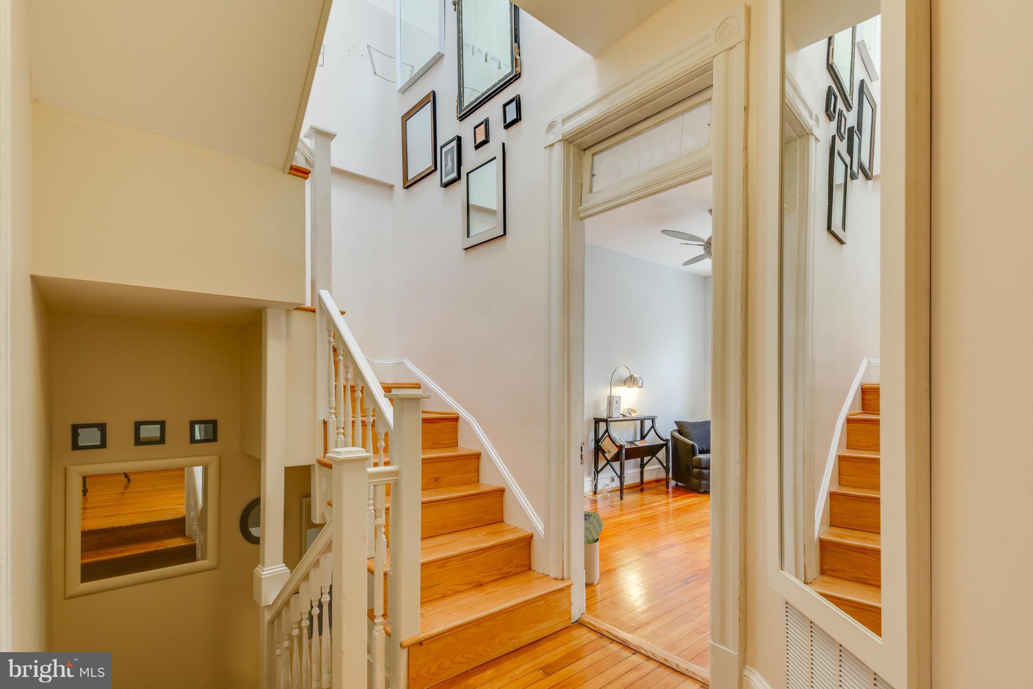 2317 Ontario Road Northwest Washington, DC 20009 - Photo 13 of 30 a view of a hallway with wooden floor and staircase