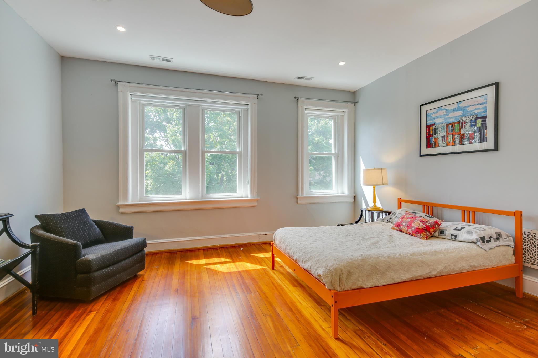 2317 Ontario Road Northwest Washington, DC 20009 - Photo 14 of 30 a bedroom with a bed and glass window