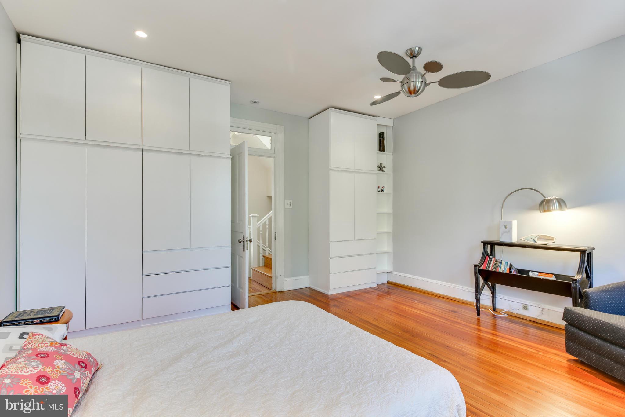 2317 Ontario Road Northwest Washington, DC 20009 - Photo 15 of 30 a bedroom with a bed and a chandelier