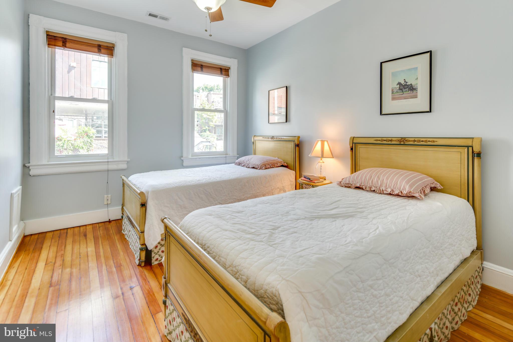2317 Ontario Road Northwest Washington, DC 20009 - Photo 16 of 30 a bedroom with a bed and wooden floor