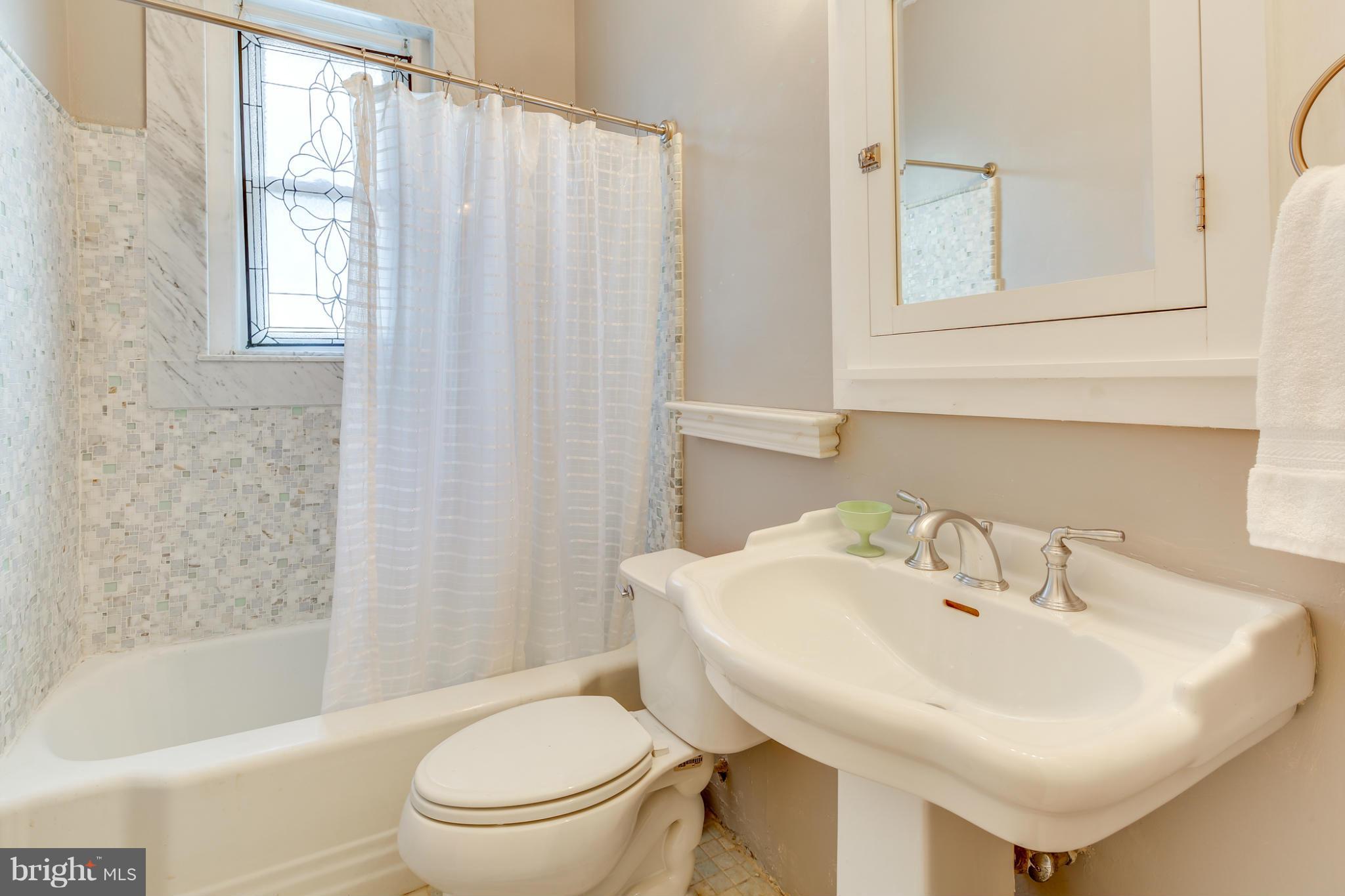 2317 Ontario Road Northwest Washington, DC 20009 - Photo 17 of 30 a bathroom with a sink a toilet and a bathtub