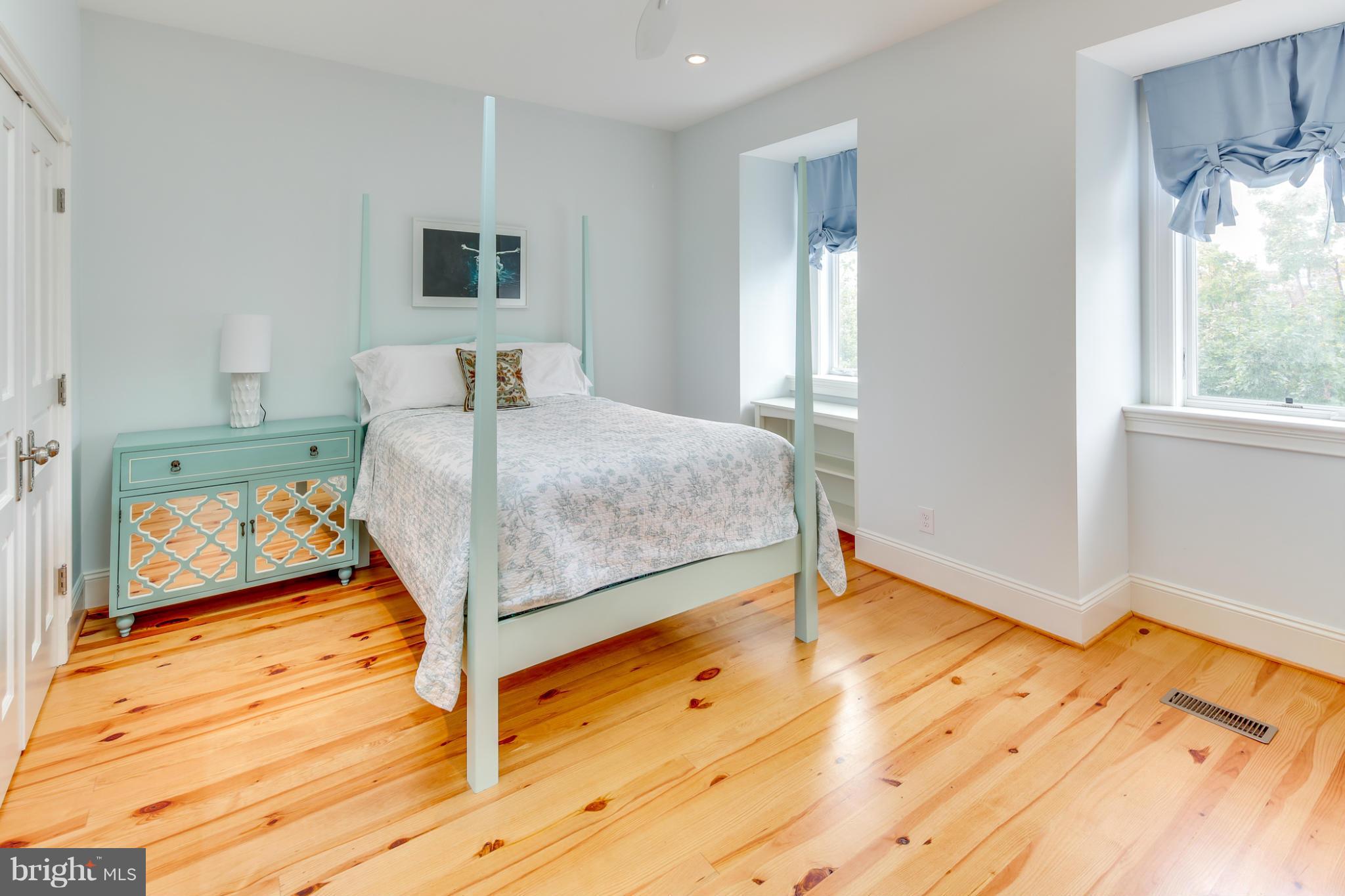 2317 Ontario Road Northwest Washington, DC 20009 - Photo 19 of 30 a bedroom with a bed and wooden floor