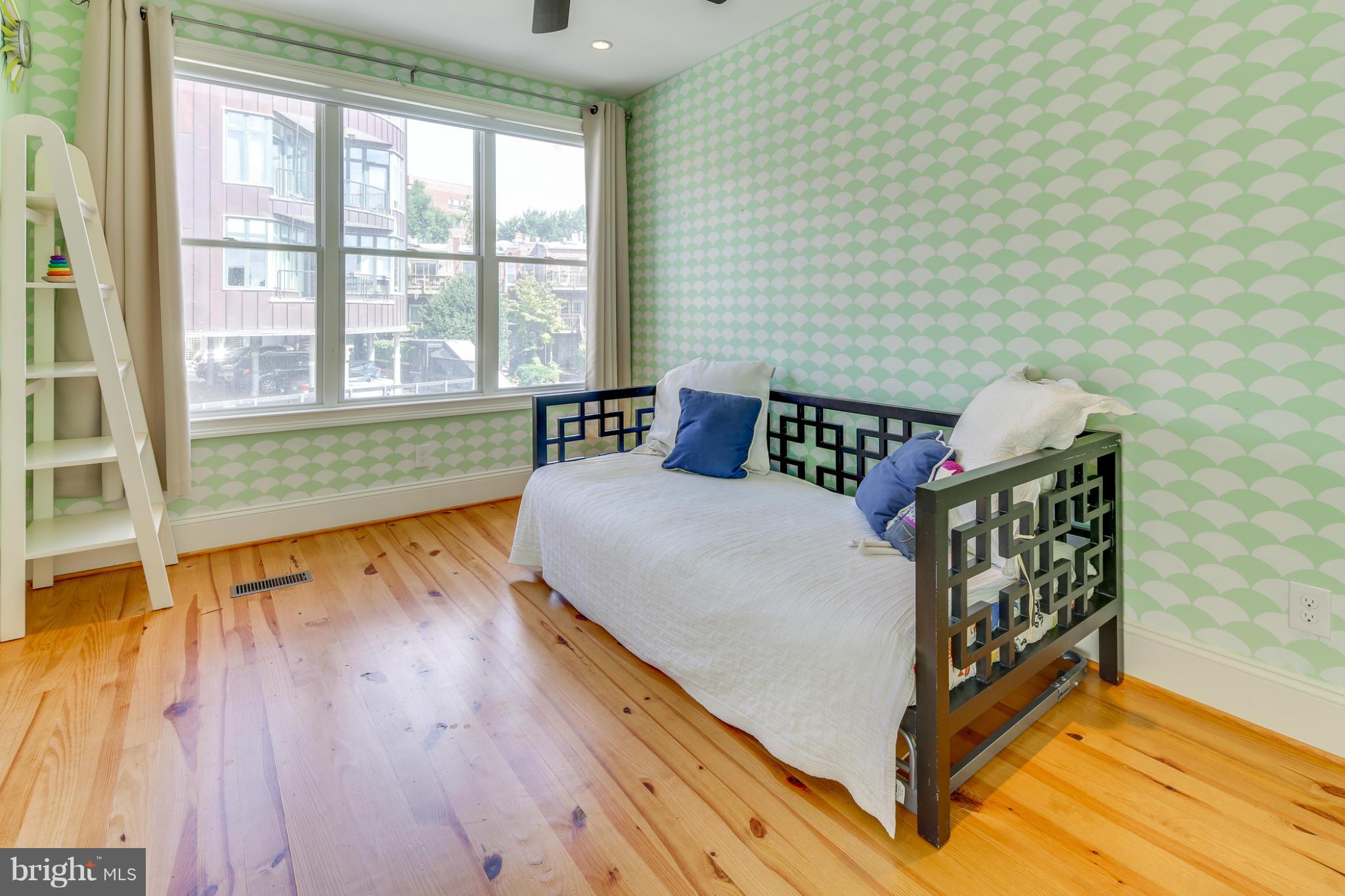 2317 Ontario Road Northwest Washington, DC 20009 - Photo 21 of 30 a bedroom with furniture and wooden floor
