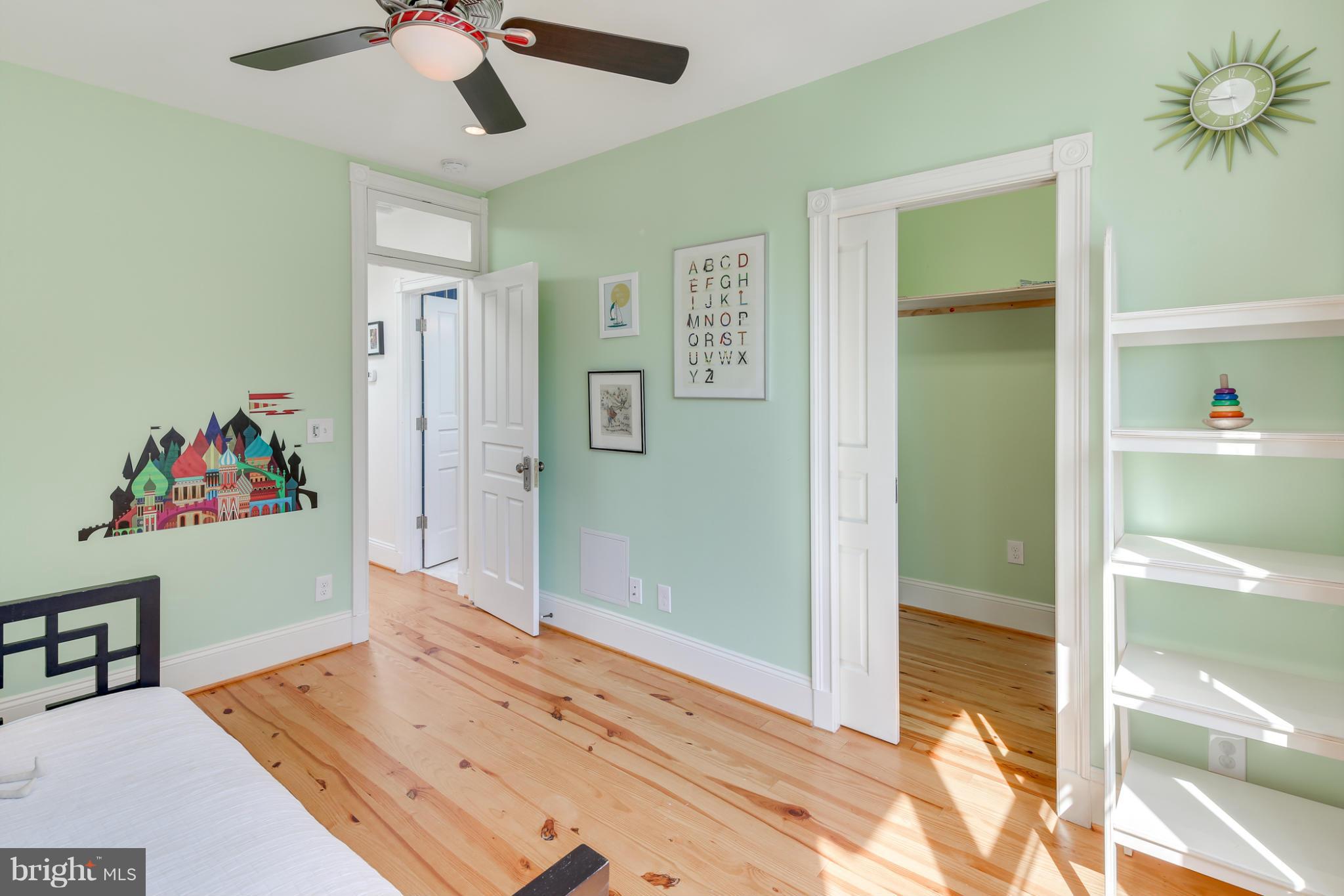 2317 Ontario Road Northwest Washington, DC 20009 - Photo 22 of 30 a bedroom with a bed and a chandelier