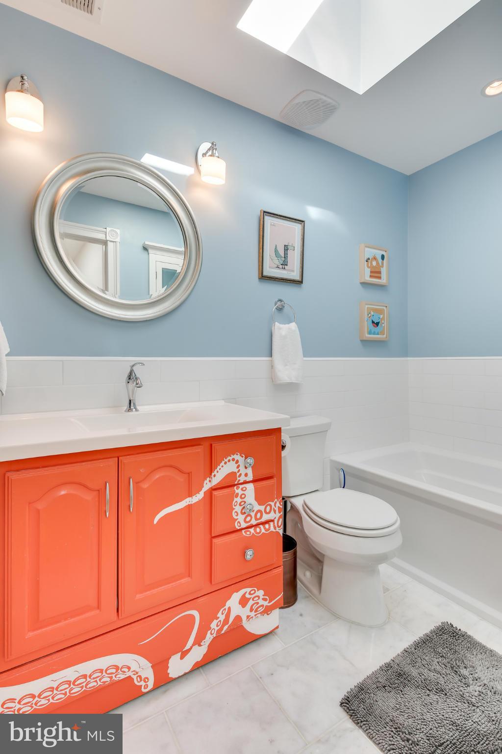 2317 Ontario Road Northwest Washington, DC 20009 - Photo 23 of 30 a bathroom with a toilet a sink and a mirror