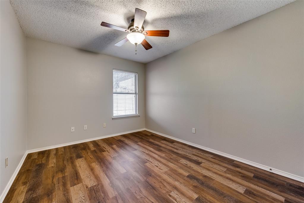 8129 Spruce Valley Drive Fort Worth, TX 76137 - Photo 14 of 19 wooden floor in an empty room with a window