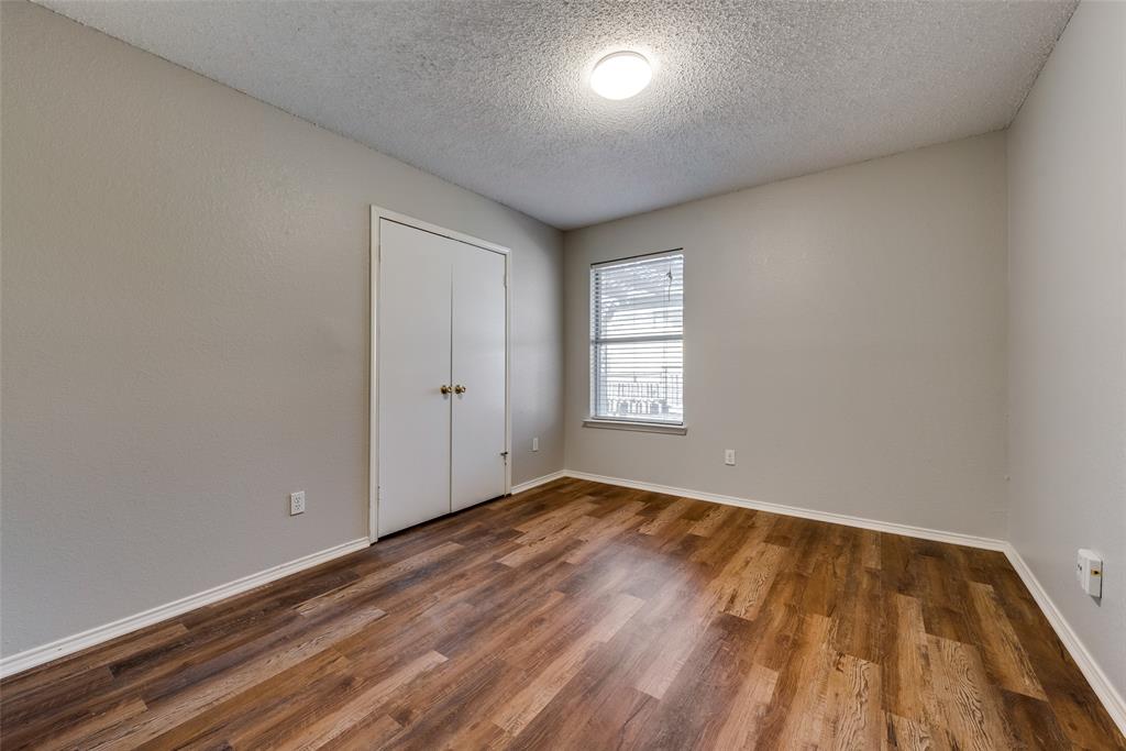 8129 Spruce Valley Drive Fort Worth, TX 76137 - Photo 15 of 19 an empty room with wooden floor and windows