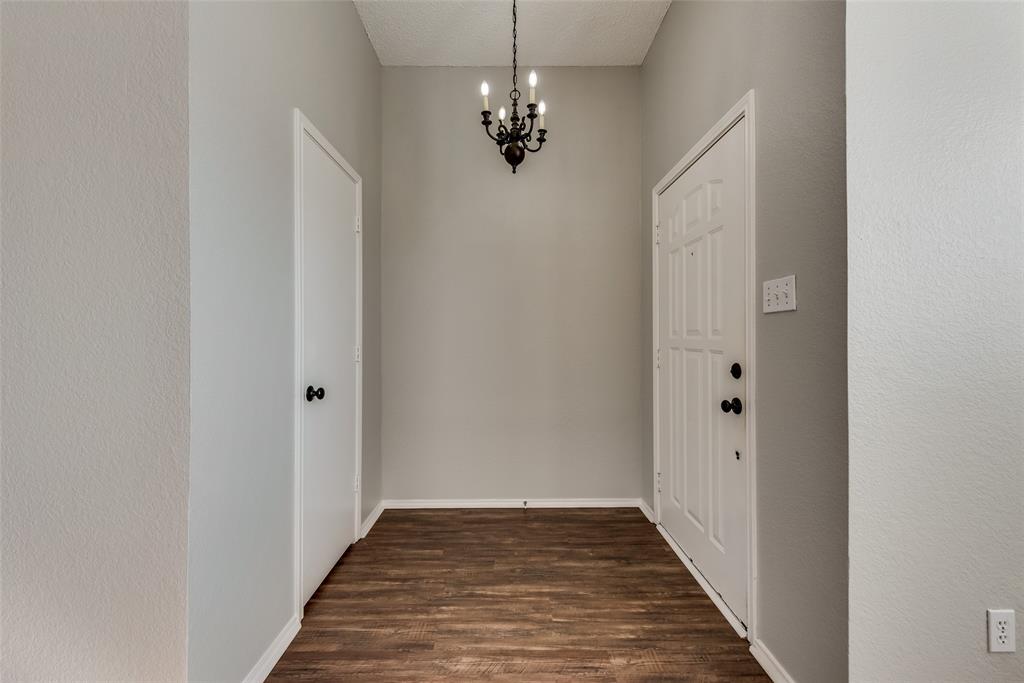 8129 Spruce Valley Drive Fort Worth, TX 76137 - Photo 2 of 19 a view of a hallway with wooden floor