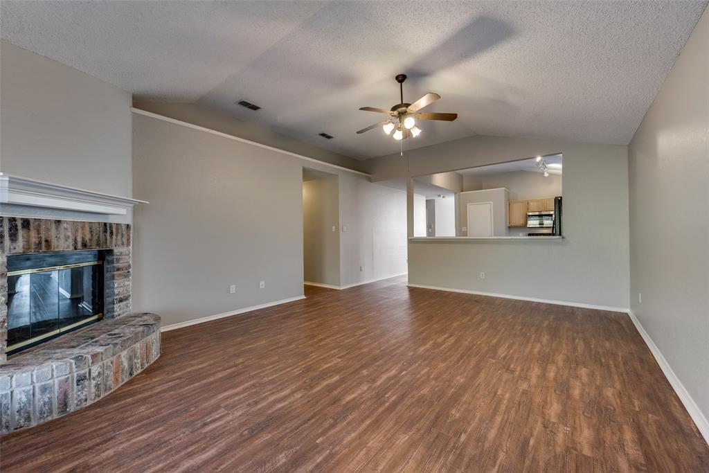 8129 Spruce Valley Drive Fort Worth, TX 76137 - Photo 6 of 19 a view of an empty room with wooden floor and a window