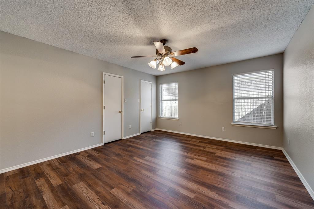 8129 Spruce Valley Drive Fort Worth, TX 76137 - Photo 9 of 19 an empty room with wooden floor and windows