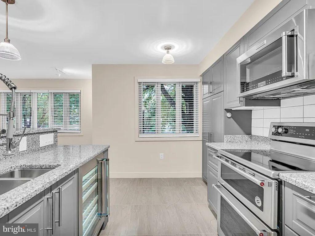 220 2nd Street Southeast, Unit 103 Washington, DC 20003 - Photo 13 of 21 a kitchen with stainless steel appliances granite countertop a sink stove and cabinets