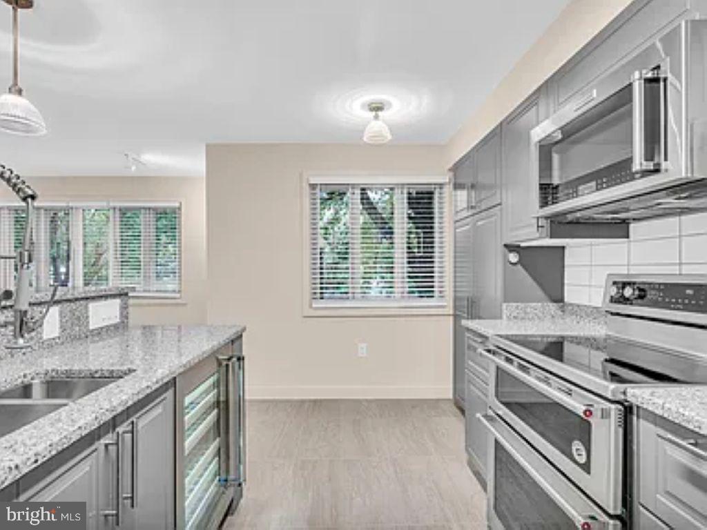 220 2nd Street Southeast, Unit 103 Washington, DC 20003 - Photo 6 of 21 a kitchen with stainless steel appliances granite countertop a sink stove and cabinets