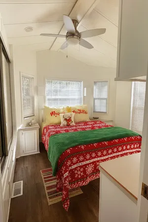 a bedroom with a bed and a large window