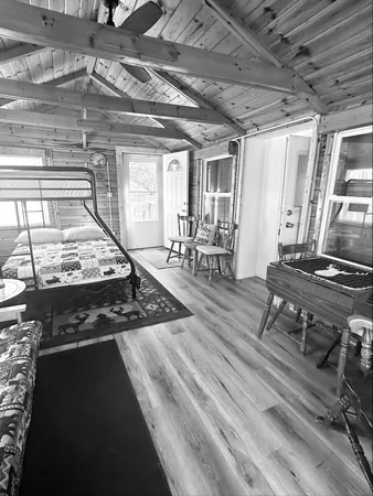 a bedroom with furniture and a wooden floor