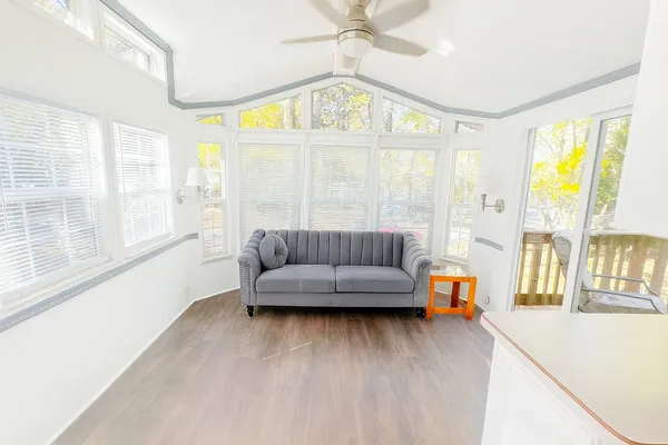 a kitchen with a sink cabinets and wooden floor