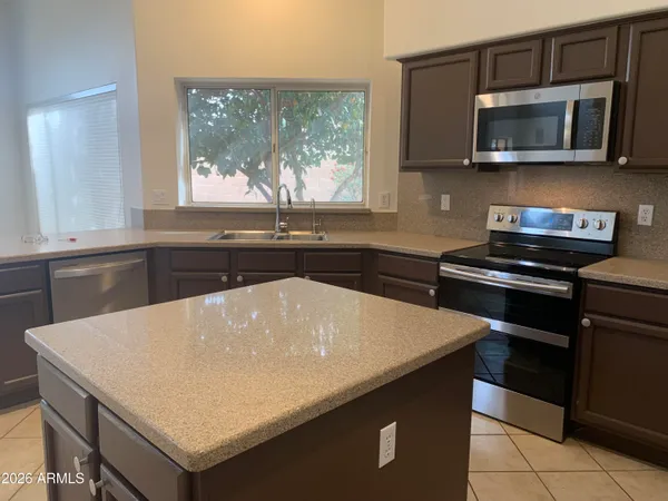 a kitchen with a sink stove and microwave
