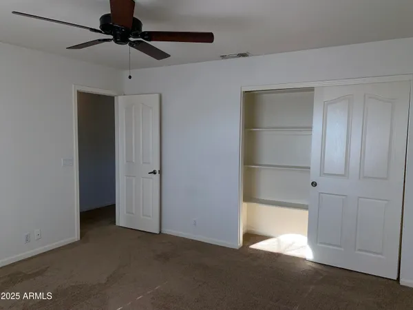 a view of a livingroom with wooden floor and a fireplace